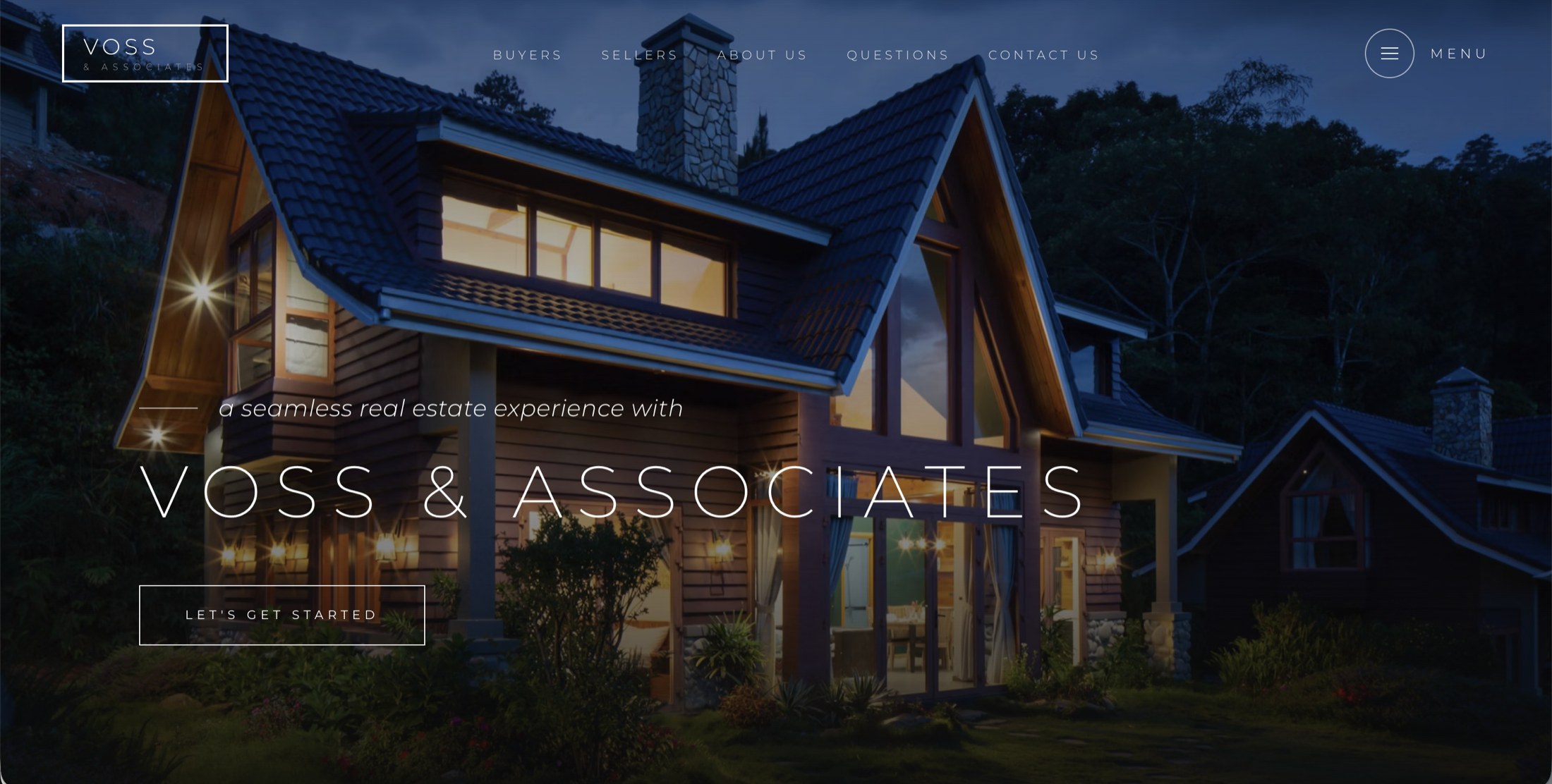 The Voss & Associates real estate homepage at night, a wide-angle exterior of a cabin with a bold VOSS & ASSOCIATES wordmark over it