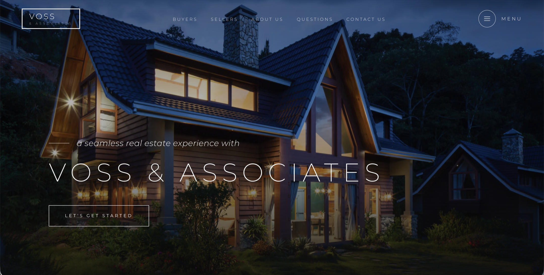 The Voss & Associates real estate homepage at night, a wide-angle exterior of a cabin with a bold VOSS & ASSOCIATES wordmark over it